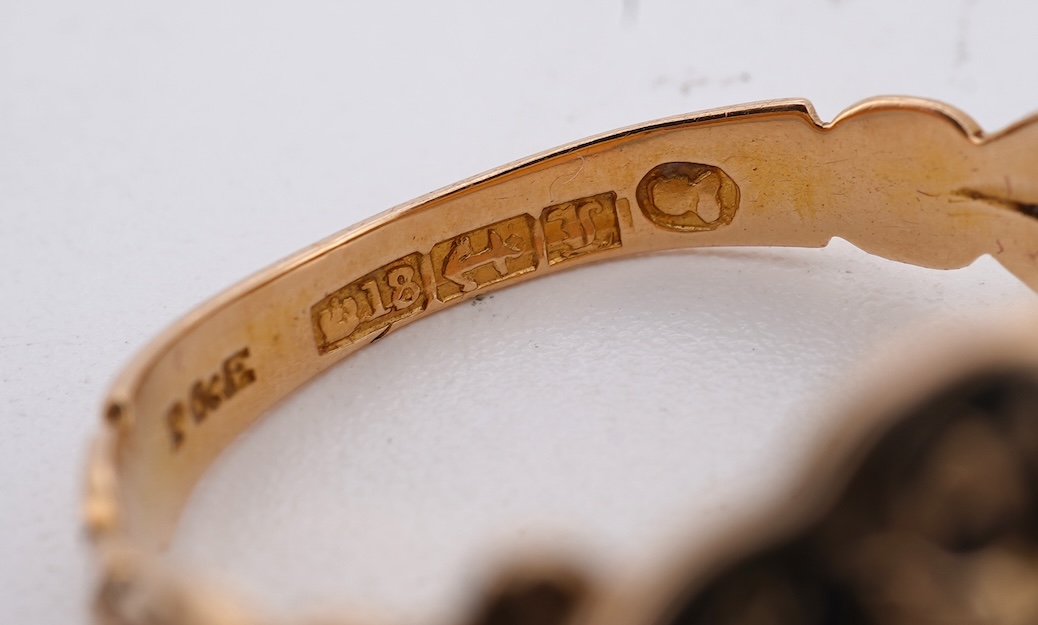 A William IV 18ct gold and black enamel 'In Memory' mourning ring, with hair beneath a central glazed panel, size N, gross weight 2.8 grams.